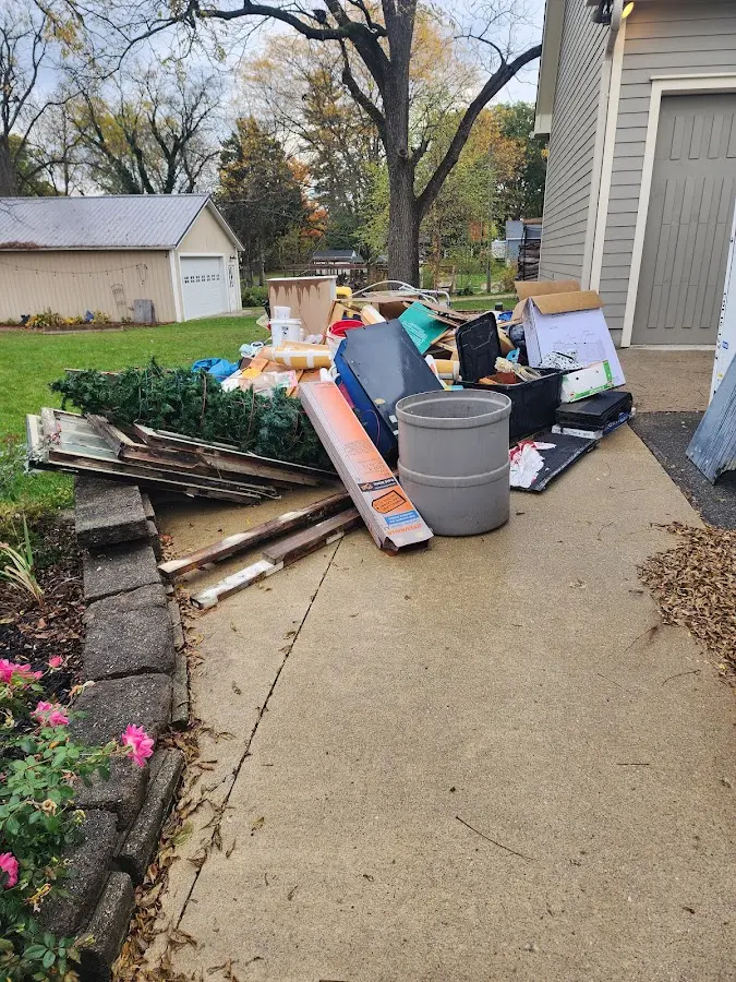 Dumpster being loaded with debris for Commercial Dumpster Rental in Claremont